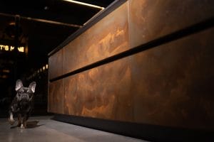 Hand-sprayed copper handleless cabinetry 