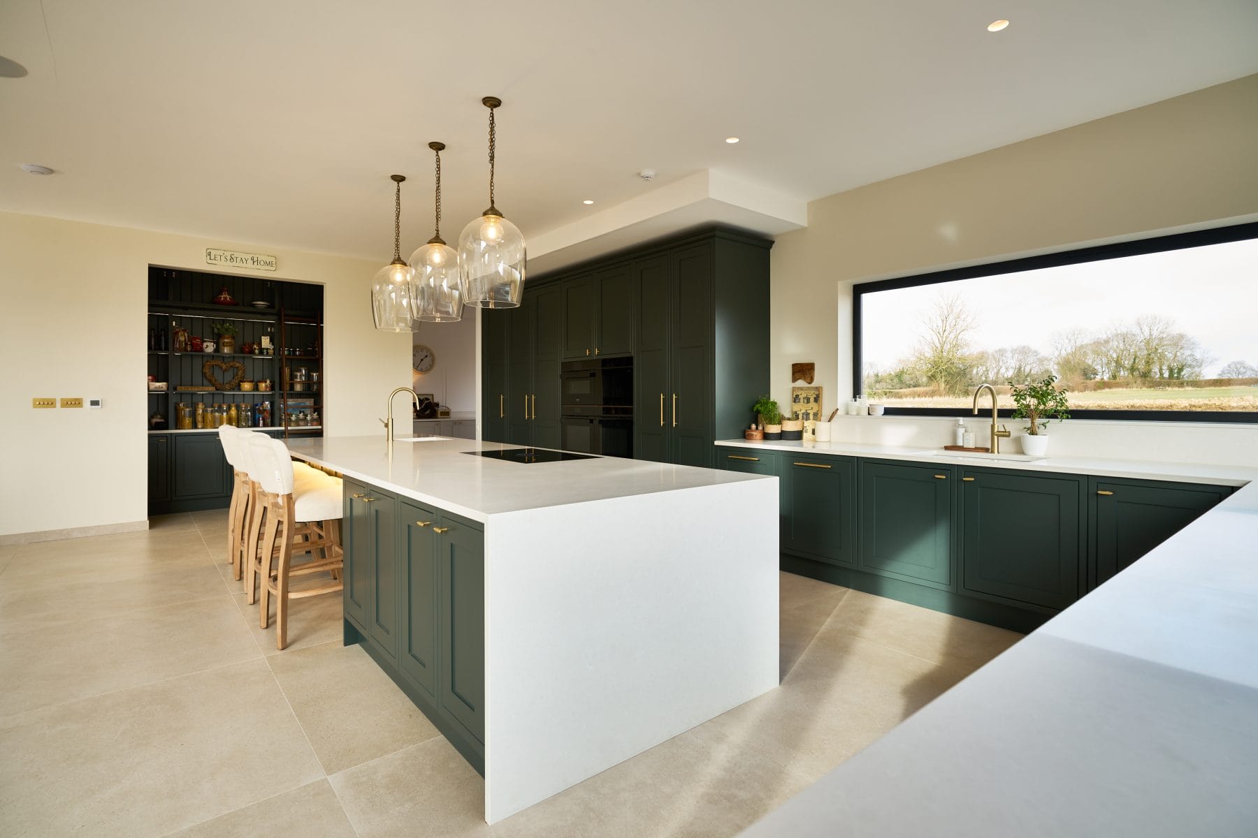 large open please bespoke in frame shaker kitchen in dark green with brushed brass knurled kitchen handles