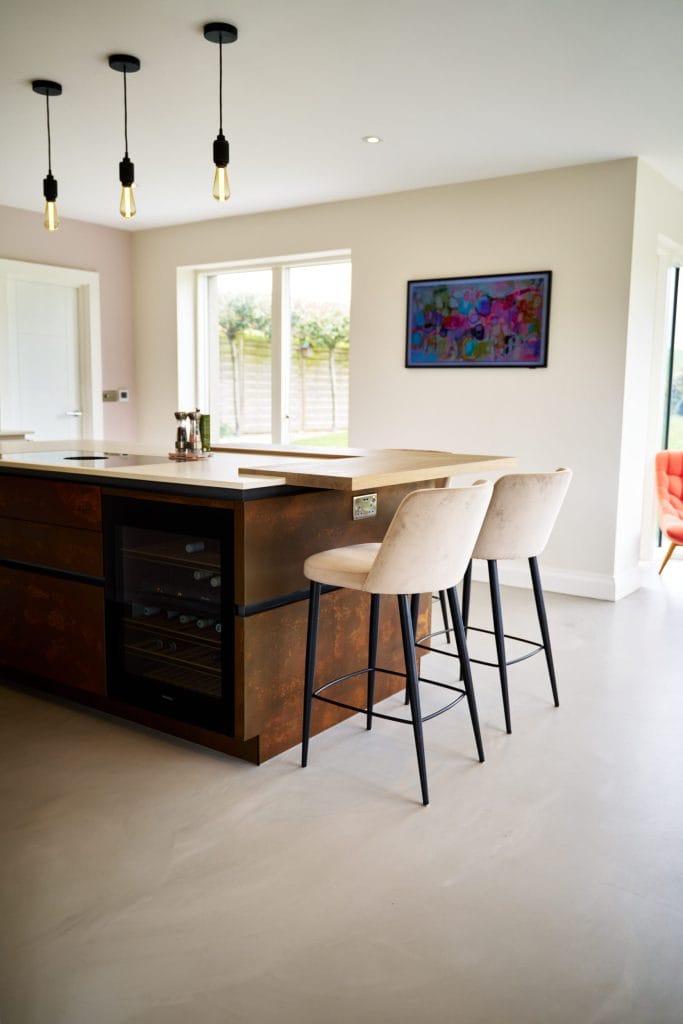 Kitchen design with Resin Cement Floor and Copper Feature Island.