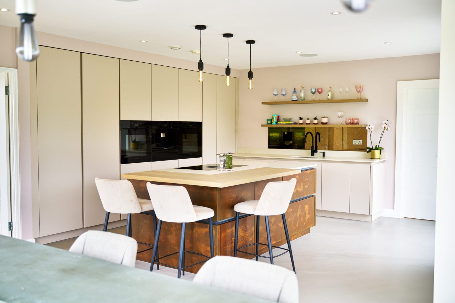 Kitchen design with Resin Cement Floor and Copper Feature Island.