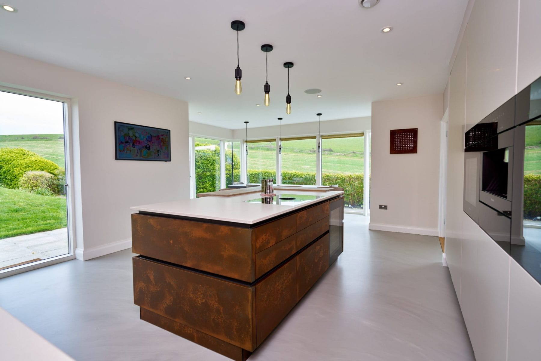 Kitchen design with Resin Cement Floor and Copper Feature Island.