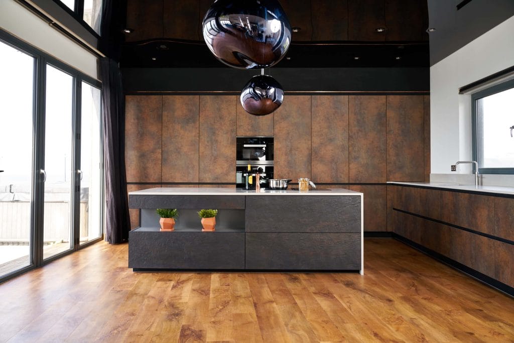 Dark, contemporary German-style kitchen with bespoke copper cupboards