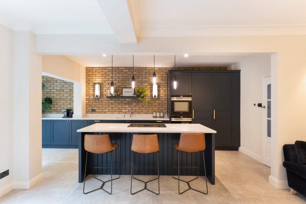 farrow and ball off black shaker kitchen design with brushed brass handles and leather bar stools