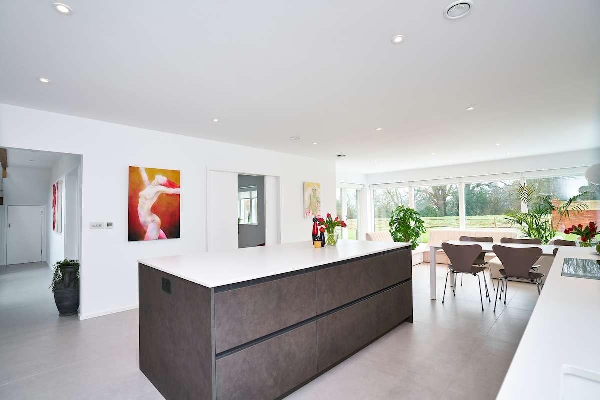 luxury handleless kitchen detail showing soft grey satin finish and minimalist storage solution