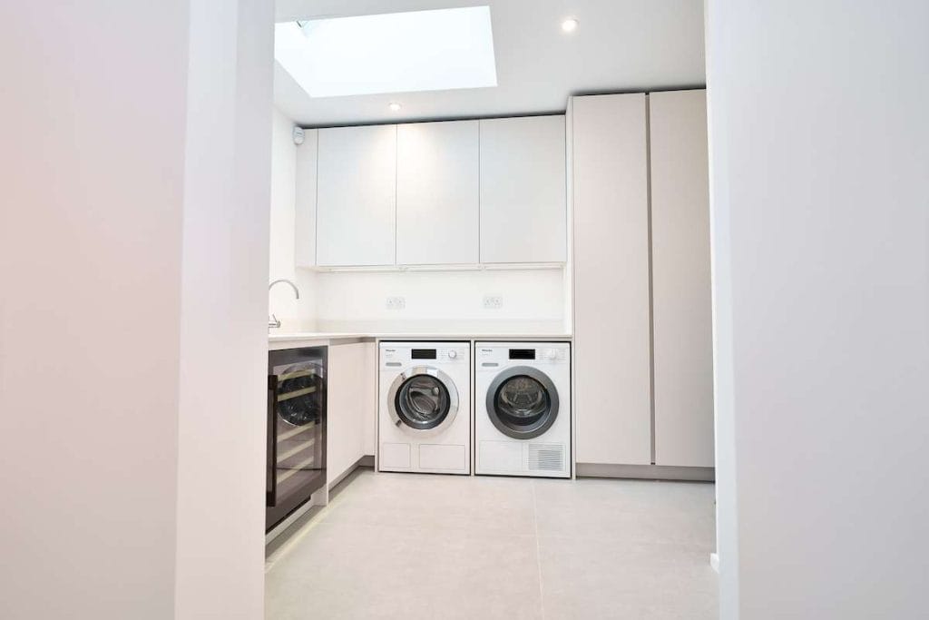 luxury handleless kitchen with secret passage doors to utility built into the kitchen units